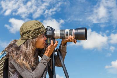 Nature woman photographer taking pictures outdoors